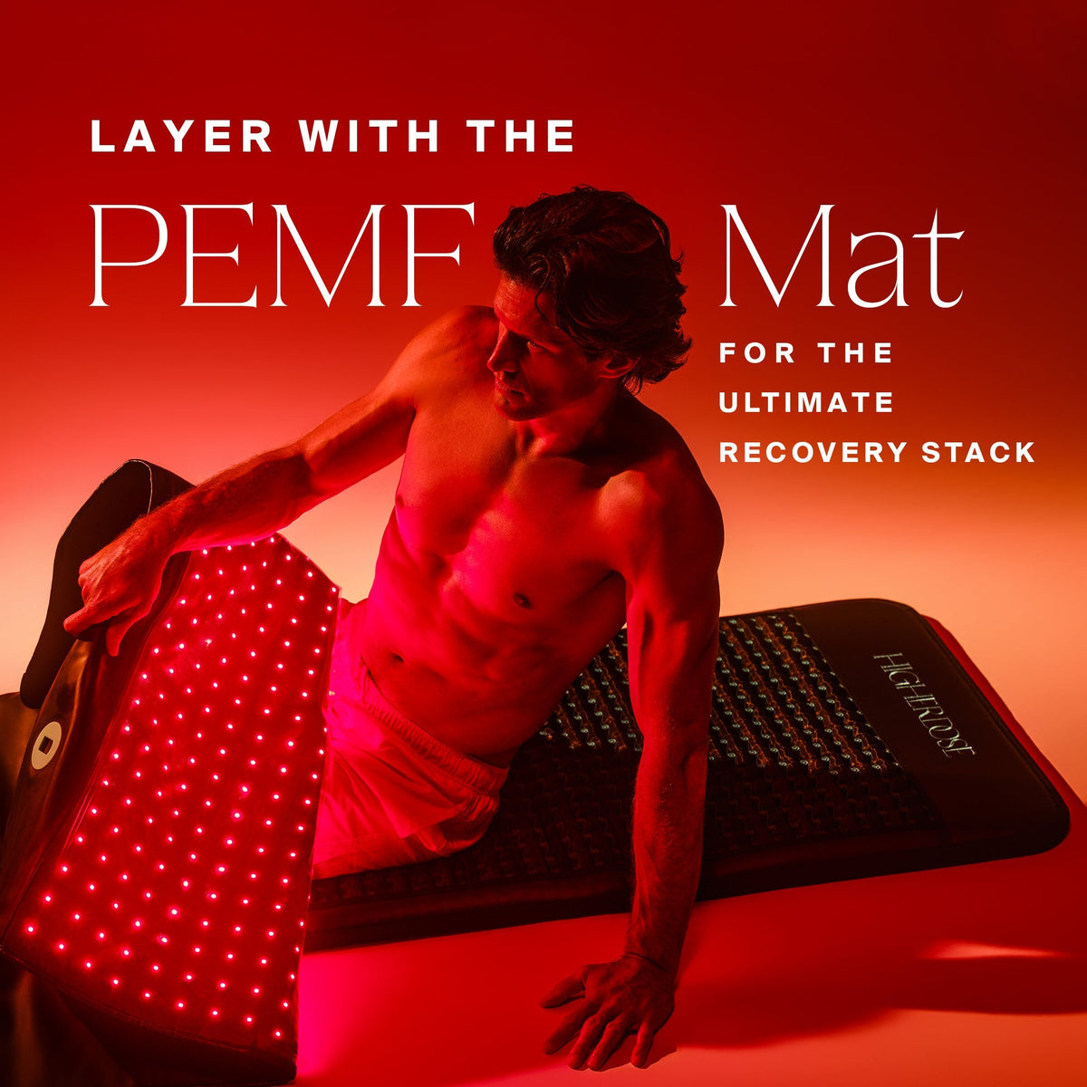 Man leaning on the HigherDOSE Full Body Red Light Mat layered with the PEMF Mat for the ultimate recovery stack