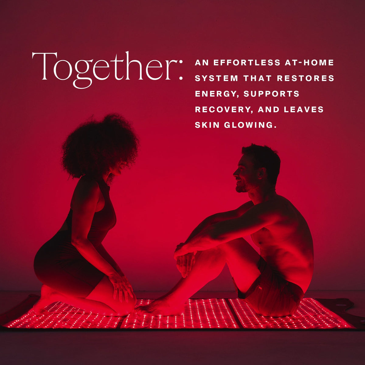Man and woman sitting in front of the HigherDOSE Full Body Red Light Mat: an effortless at-home recovery system