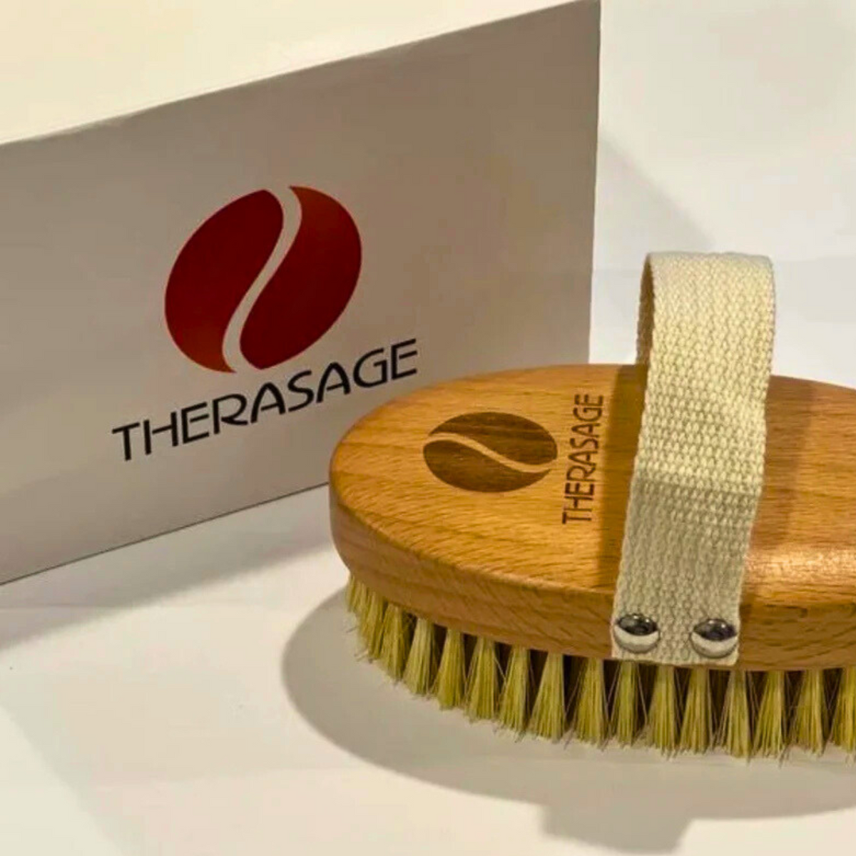 Therasage TheraBrush dry brush beside the white Therasage box