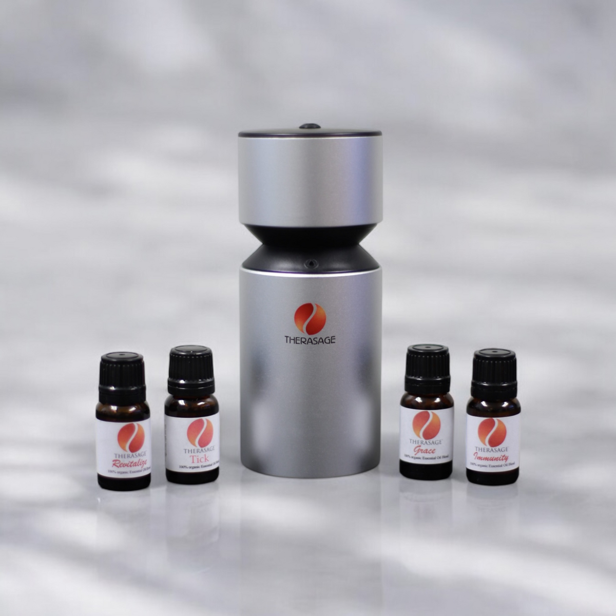 Therasage TherAroma portable atomizer diffuser with four essential oil bottles on a marble surface