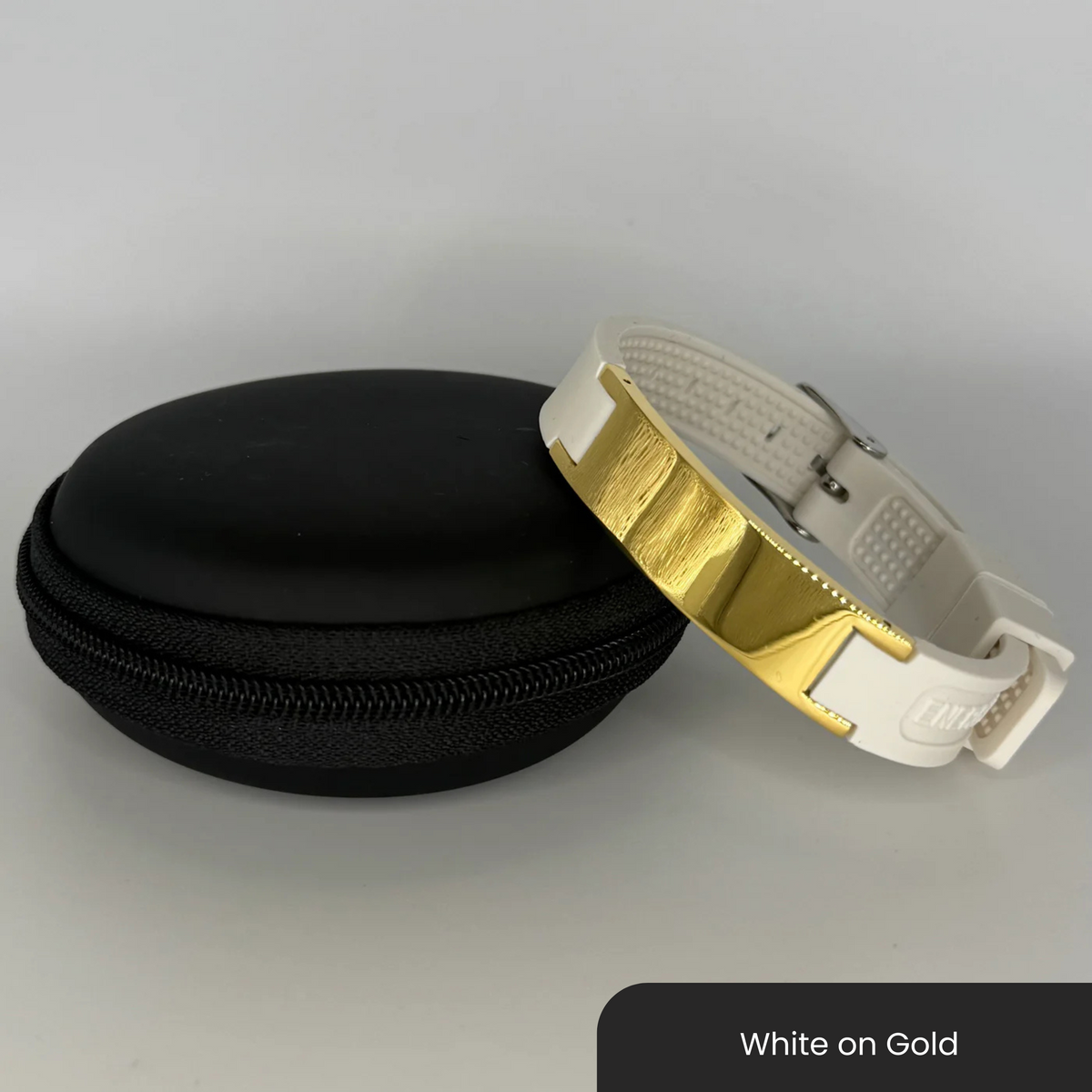 Therasage Bio Band Sport bracelet in White on Gold beside a black zip case