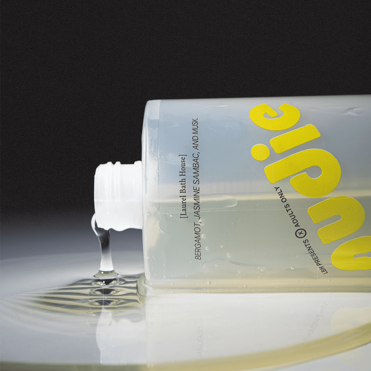 Laurel Bath House Nudie body wash bottle tipped on its side with gel pouring out