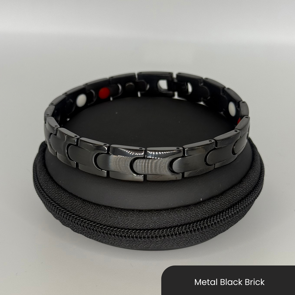 Therasage Bio Band metal bracelet in Metal Black Brick on a black zip case