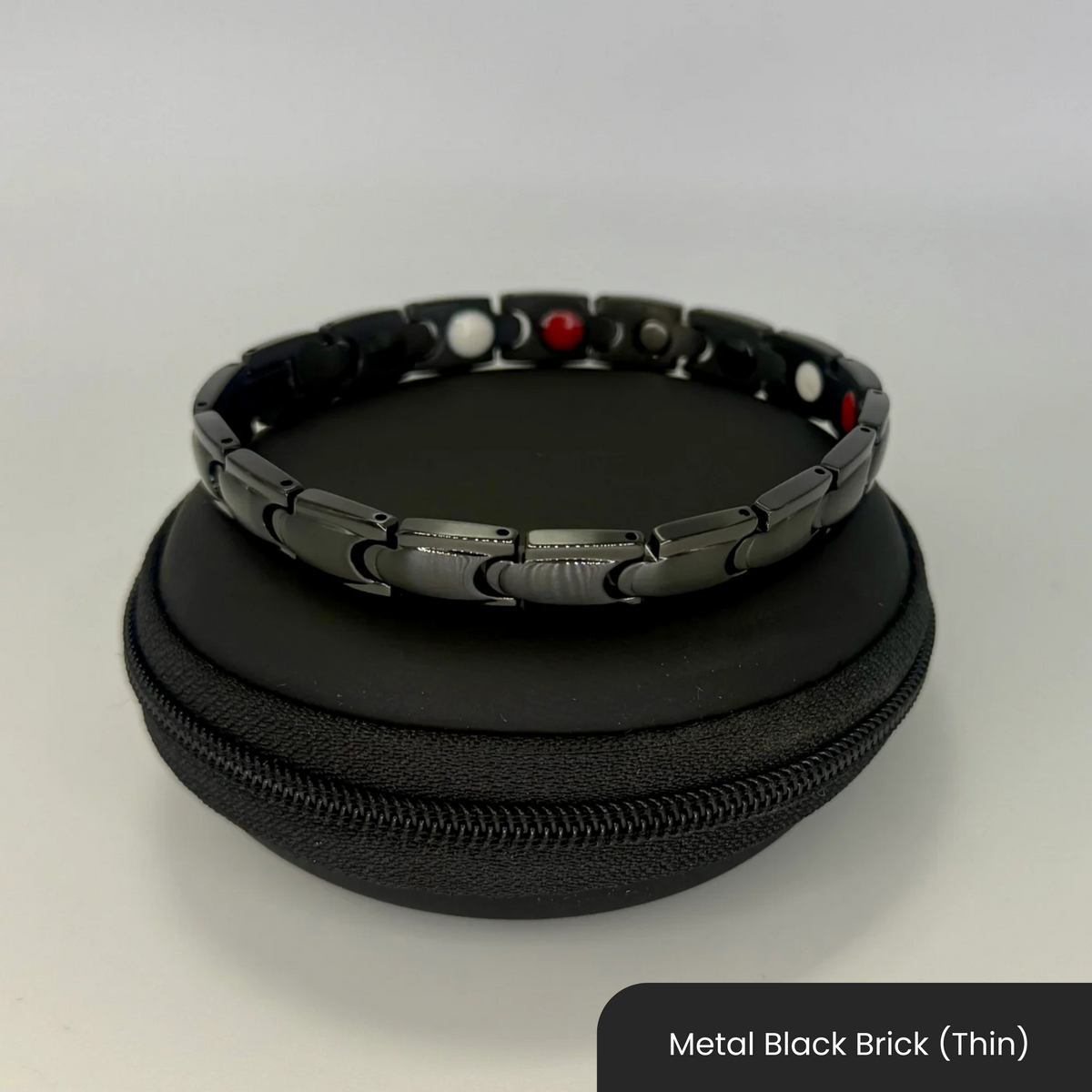 Therasage Bio Band metal bracelet in Metal Black Brick (Thin) on a black zip case