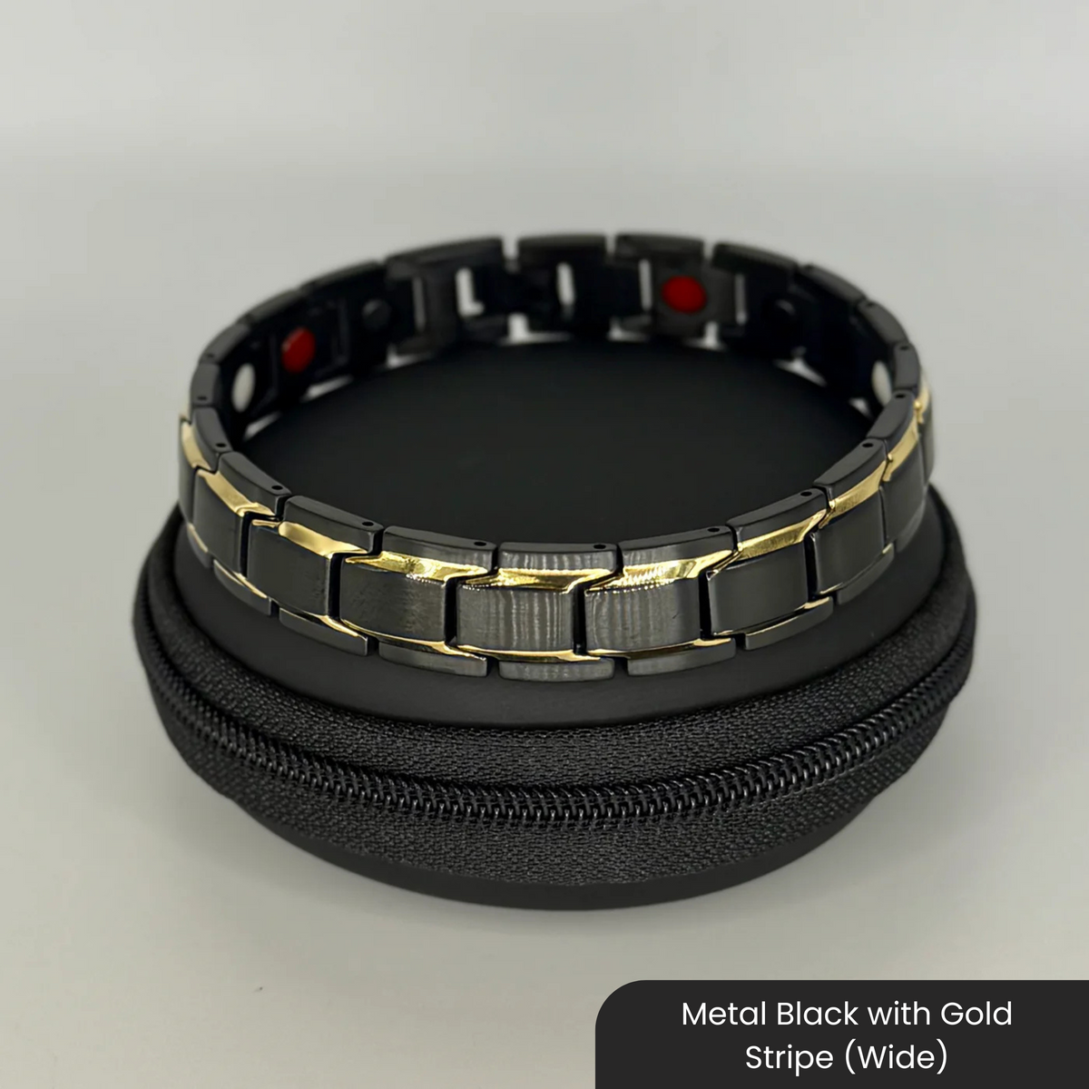 Therasage Bio Band metal bracelet in Metal Black with Gold Stripe (Wide) on a black zip case