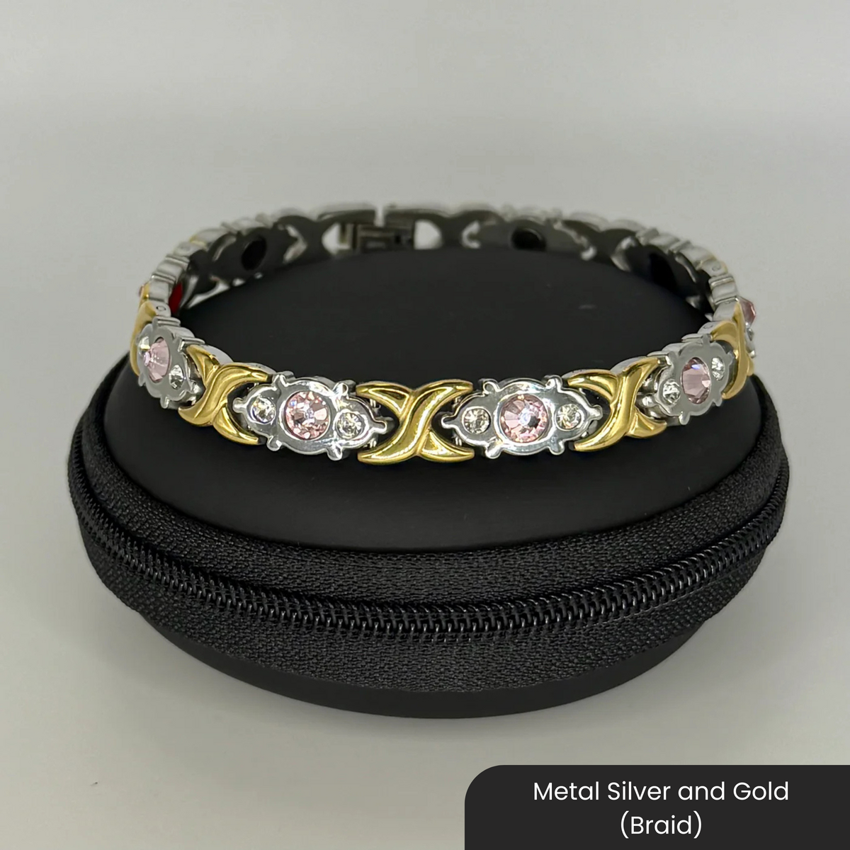 Therasage Bio Band metal bracelet in Metal Silver and Gold (Braid) with crystals on a black zip case