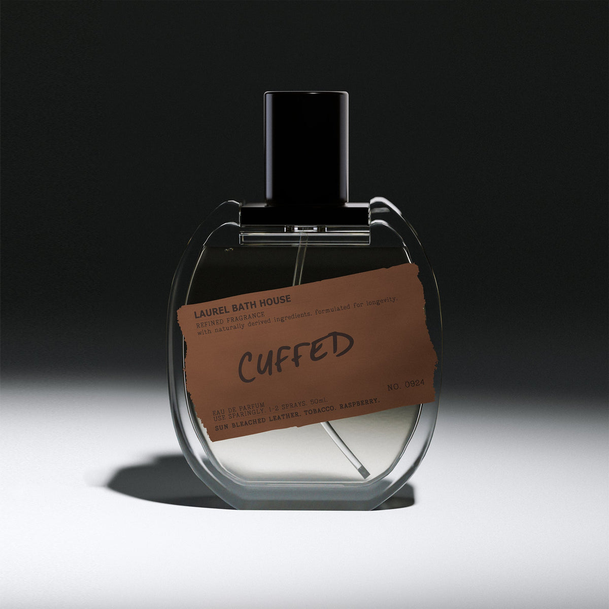 Laurel Bath House Cuffed Eau de Parfum 50 ml bottle with brown label on a dark spotlit background