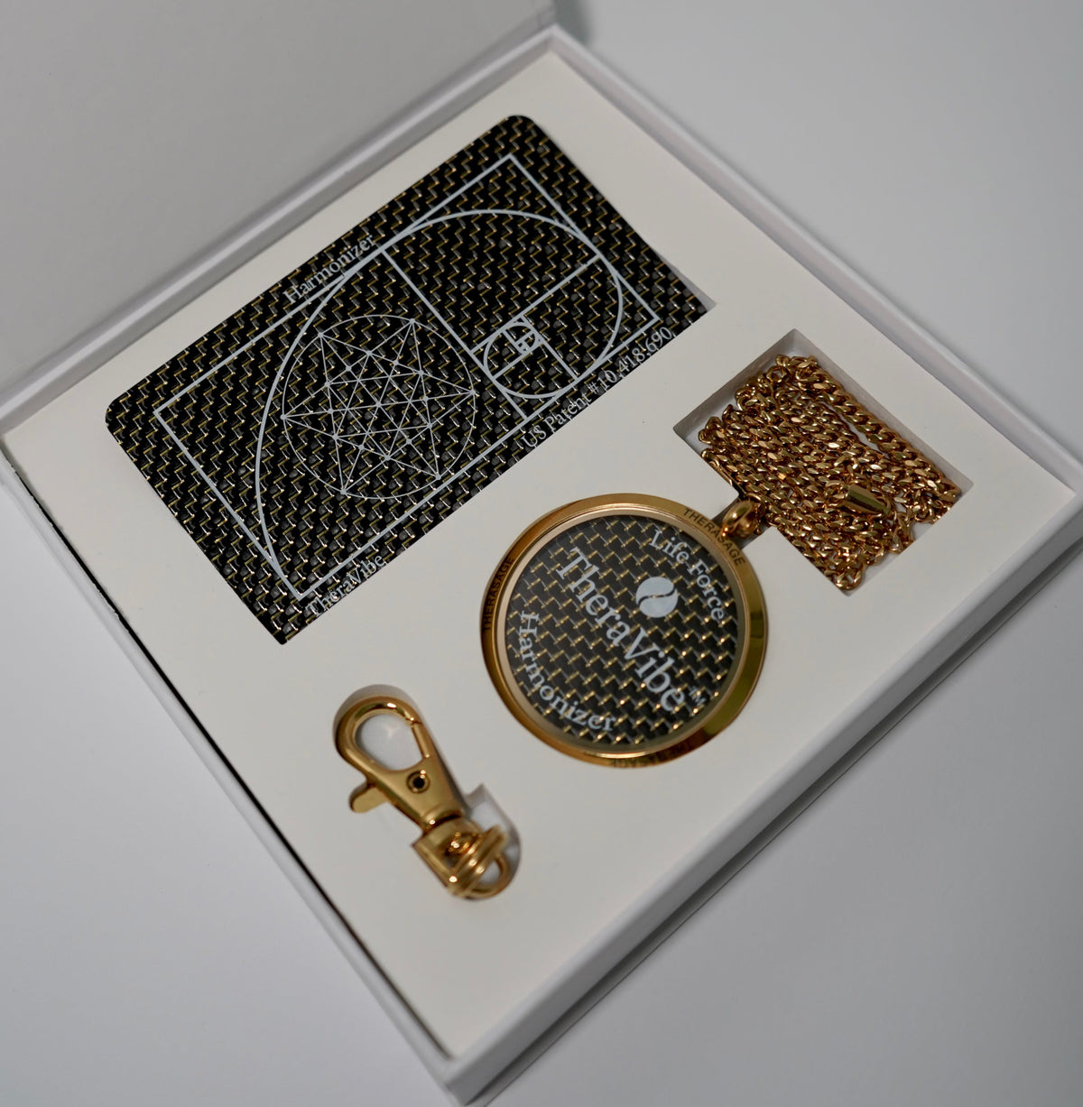 Therasage TheraVibe Quantum Card and pendant box set on a gray background