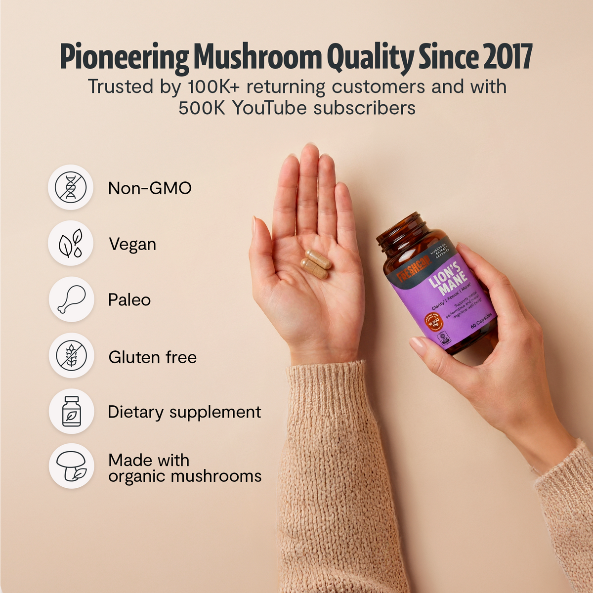 FreshCap Mushrooms Lion's Mane Capsules held in a hand: pioneering quality since 2017, non-GMO, vegan, paleo, gluten free