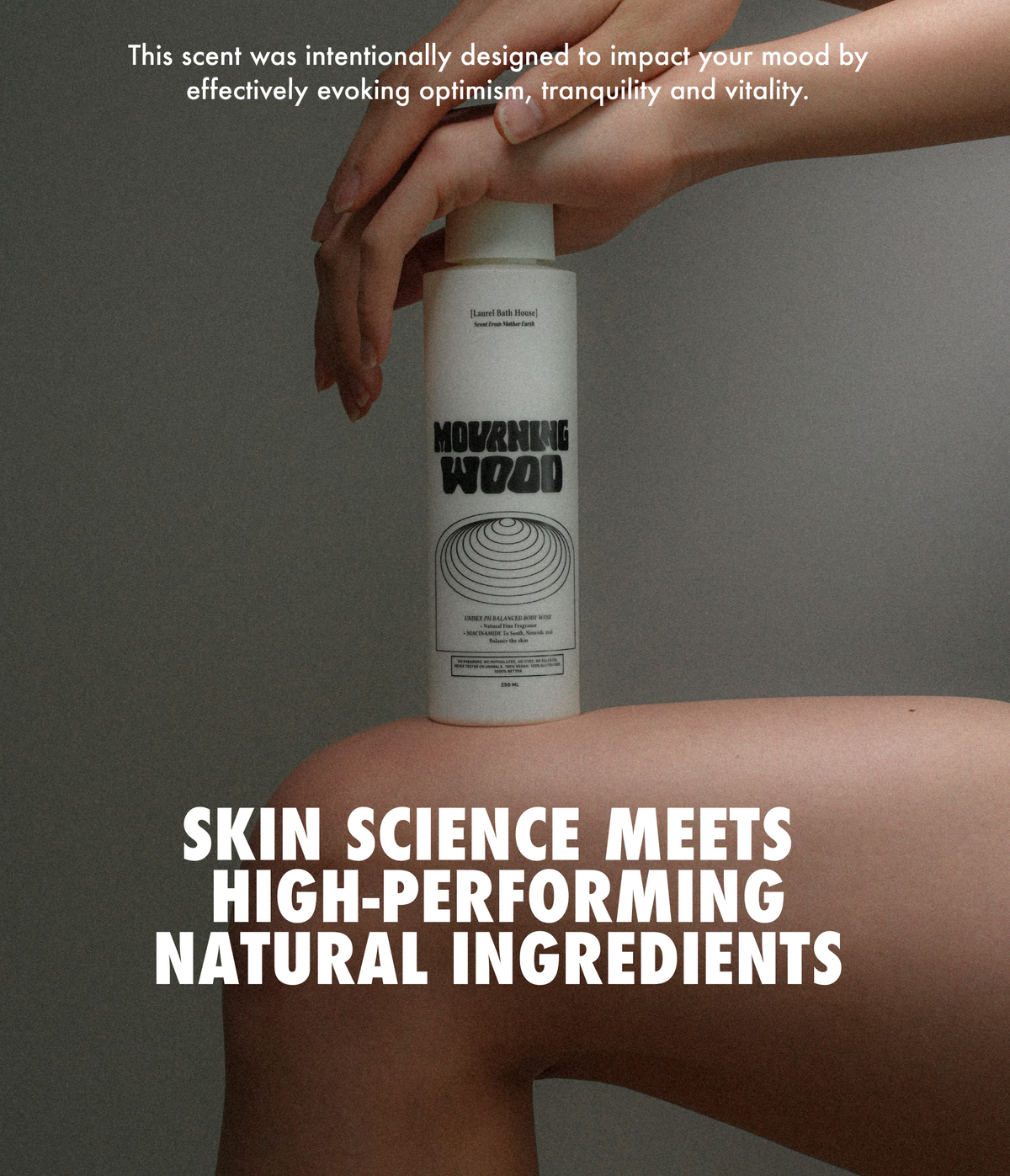 Laurel Bath House Mourning Wood body wash bottle on a woman's knee: skin science meets high-performing natural ingredients