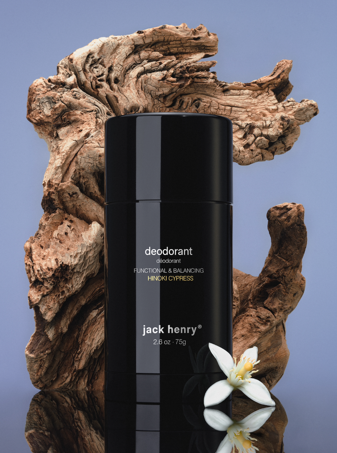 Jack Henry Deodorant in Hinoki Cypress on driftwood with a white flower