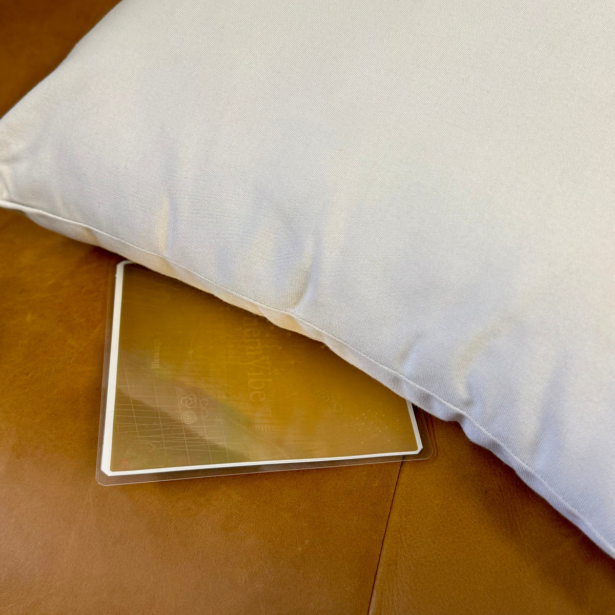 Therasage TheraVibe Sleep Card tucked under a pillow