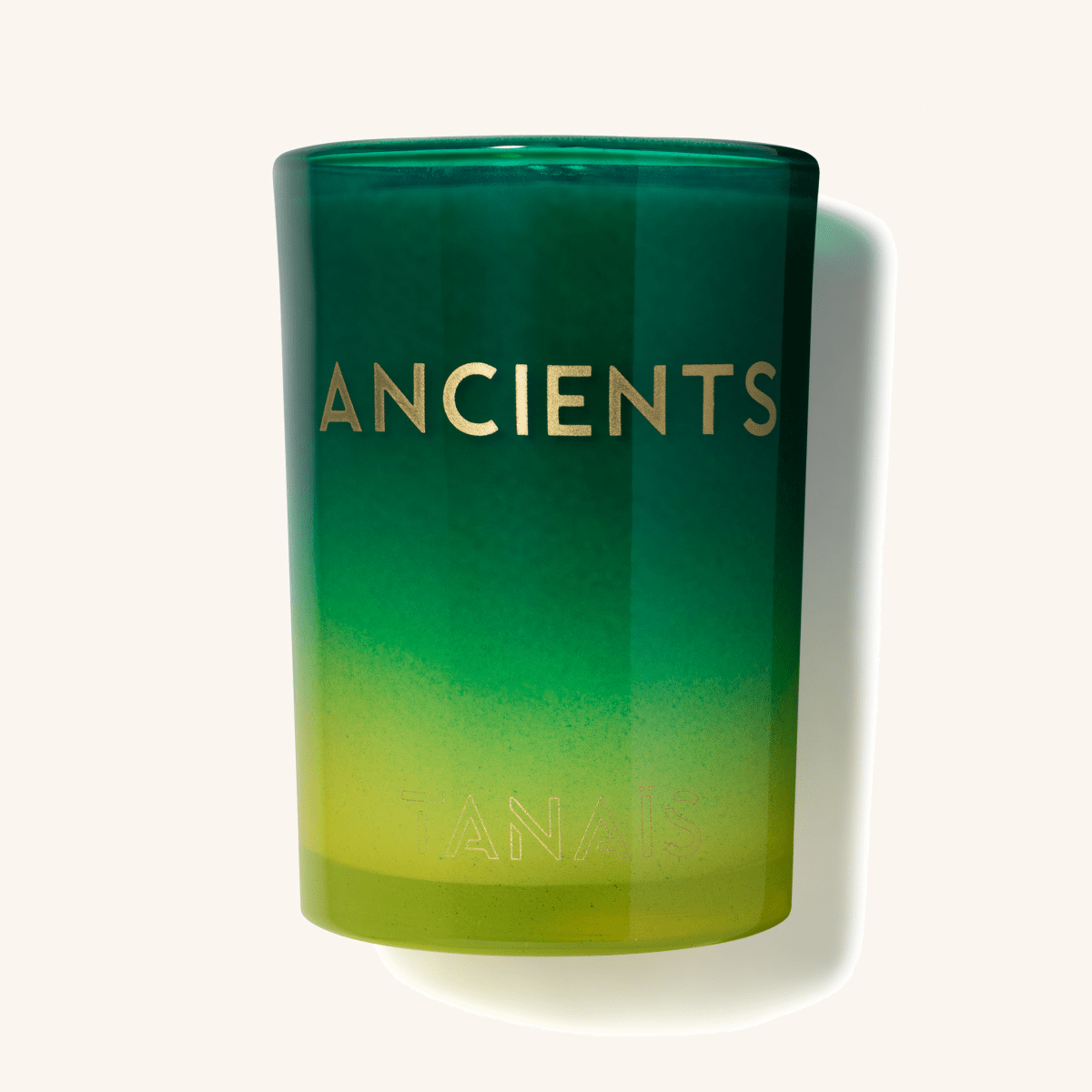 TANAÏS Ancients Candle in a green glass jar with a gold logo