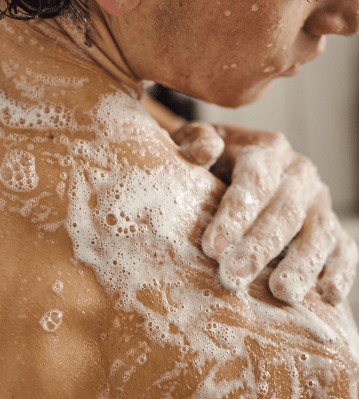 Man's shoulder covered in lather from Jack Henry Body Wash