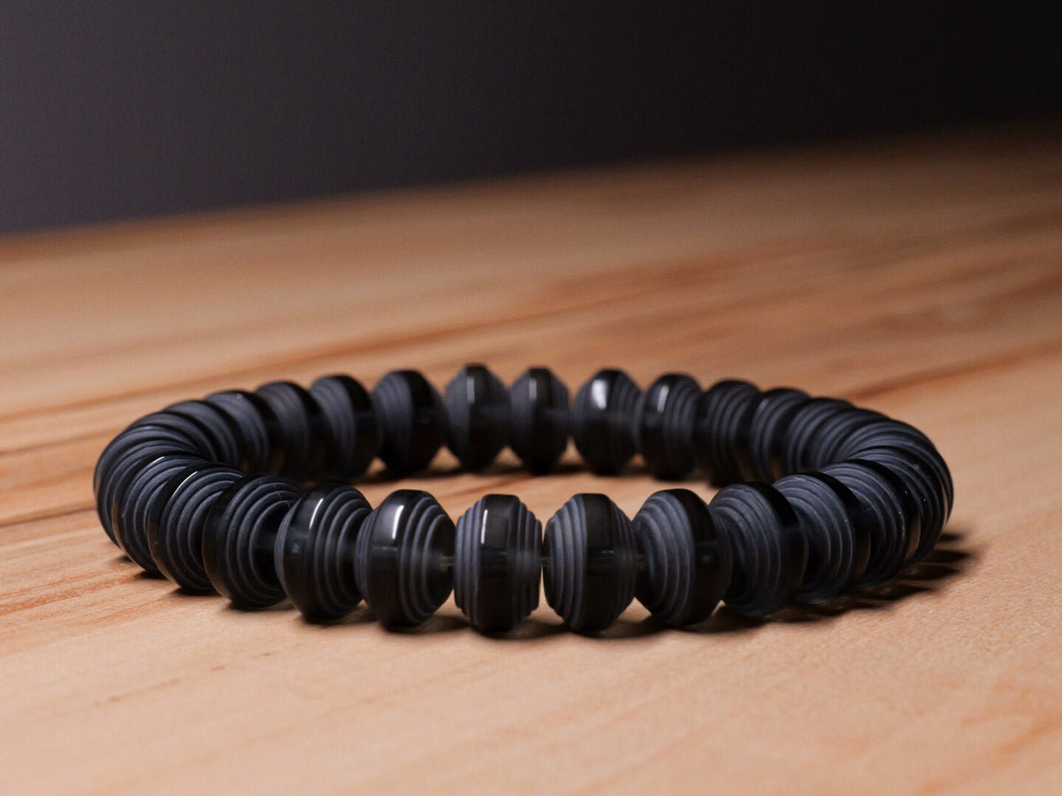Somavedic black Bracelet on a wooden table