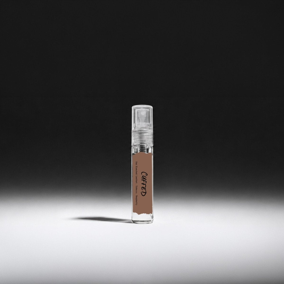 Laurel Bath House Cuffed Eau de Parfum 5 ml mini spray vial on a dark spotlit background