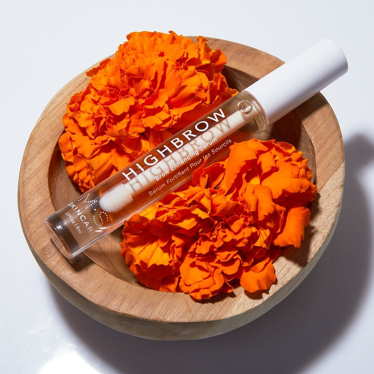 HIGHBROW by M.S. Skincare brow serum in glass bottle with white applicator wand