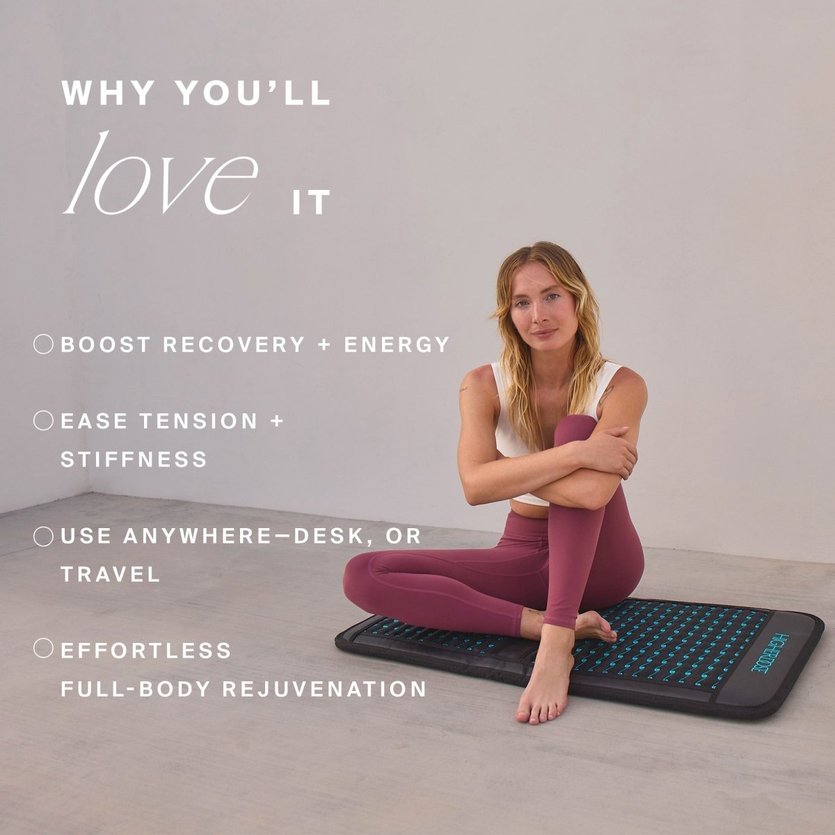 Woman sitting on the HigherDOSE Infrared PEMF Go Mat with benefits: boost recovery, ease tension, use anywhere