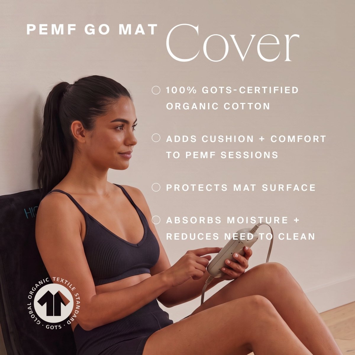 Woman holding a phone while leaning against the HigherDOSE Infrared PEMF Go Mat cover: 100% GOTS-certified organic cotton