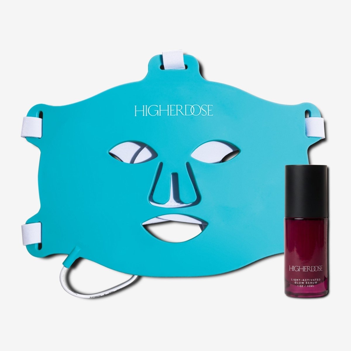 HigherDOSE Red Light Face Mask in teal with its white straps and the Glow Serum bottle on white