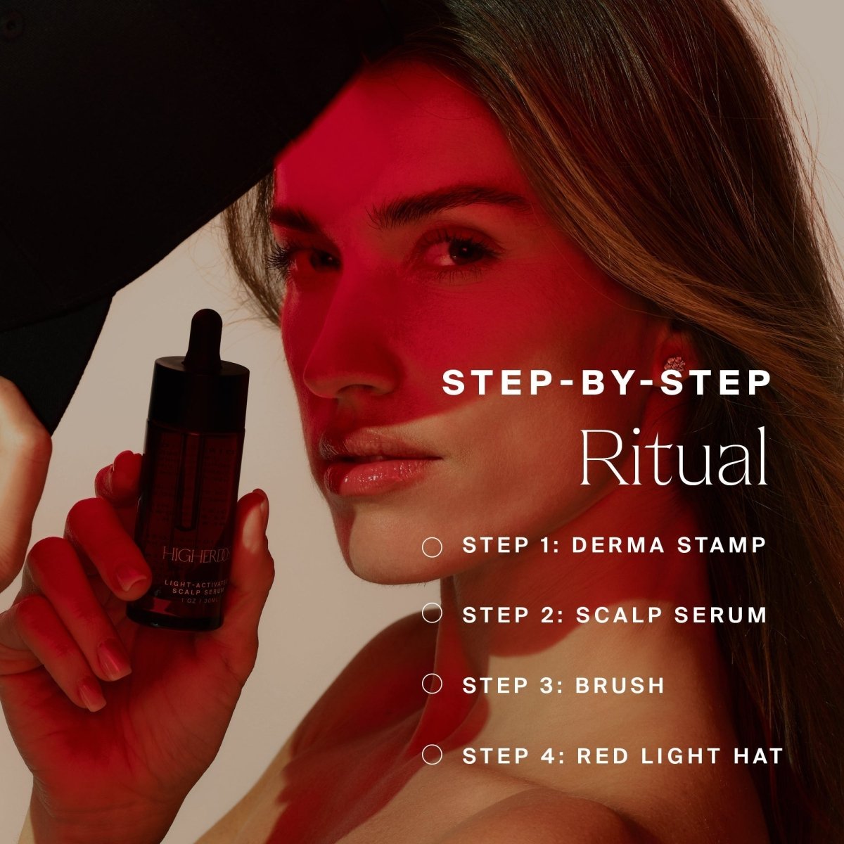 Woman holding a serum bottle under the HigherDOSE Red Light Hat: derma stamp, scalp serum, brush and red light hat ritual