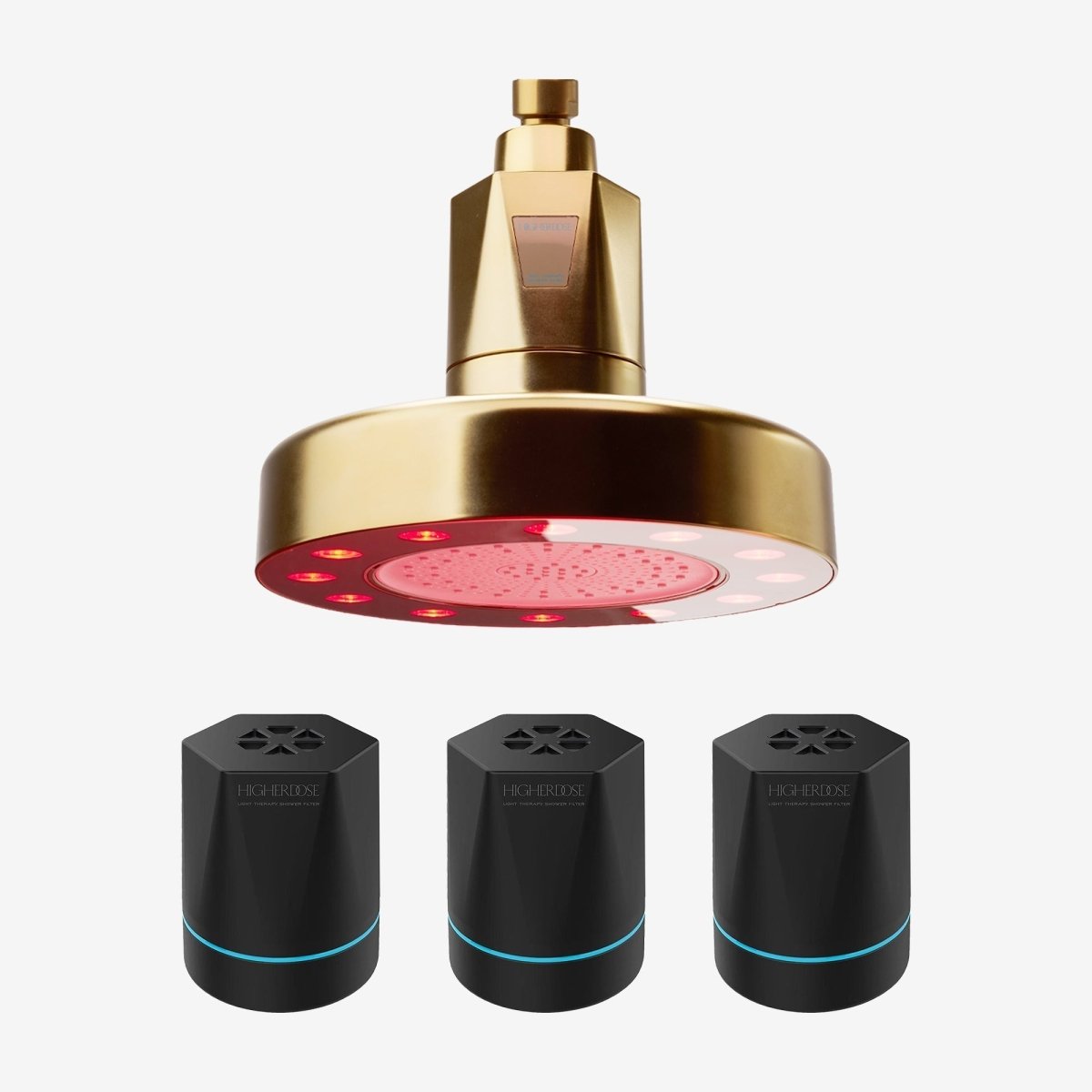 Gold HigherDOSE Red Light Showerhead Filter with three replacement filter cartridges on white