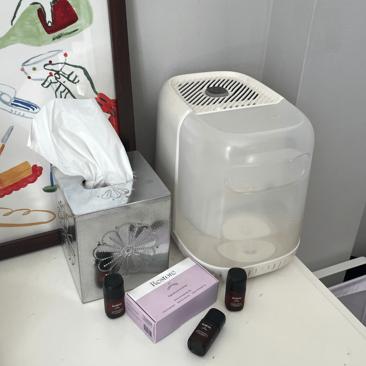 Canopy Restore Aroma Kit with a humidifier and tissue box on a bathroom shelf