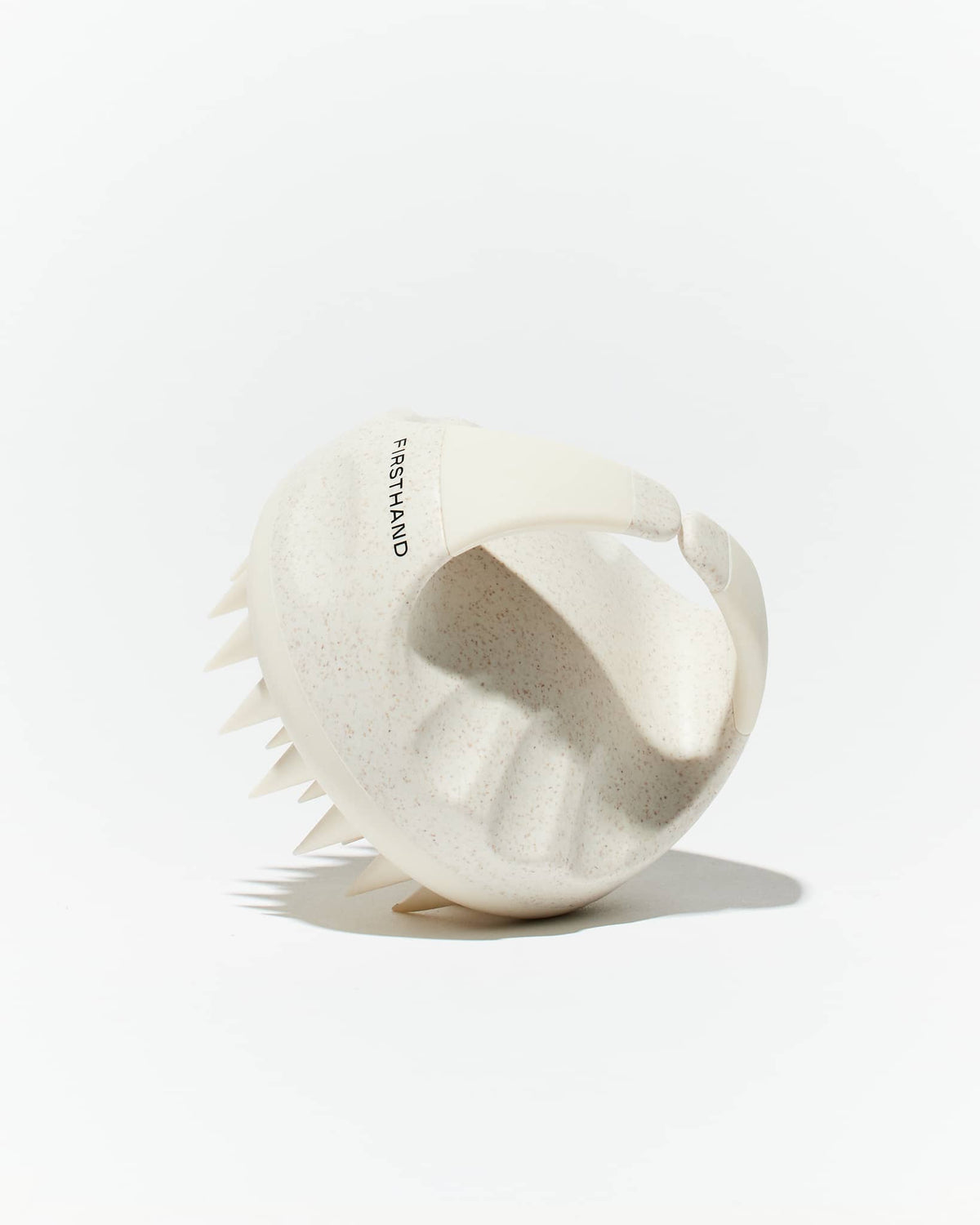 Firsthand Supply Scalp Massager in speckled cream, three-quarter view on white