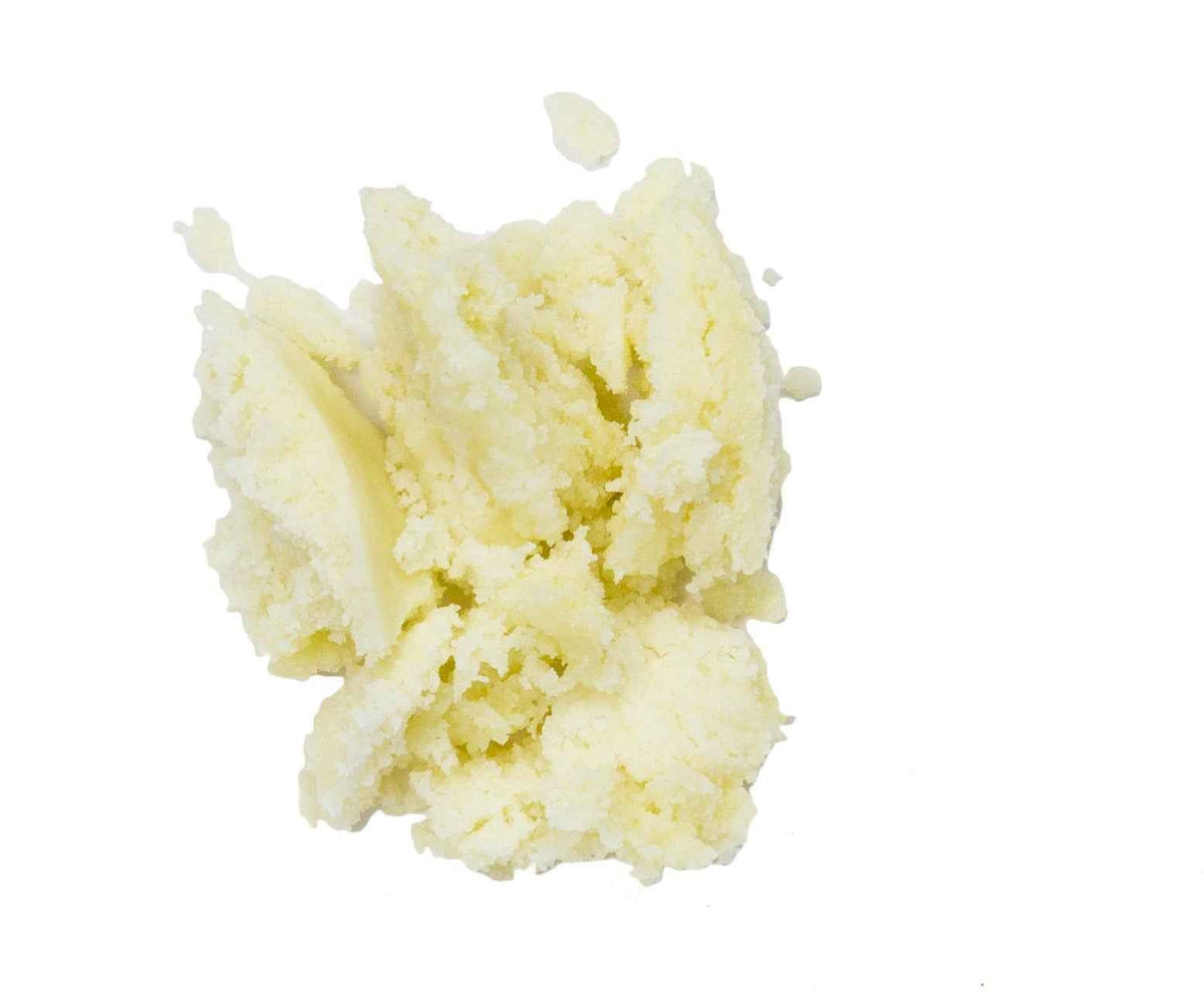 Mound of unrefined Sun Potion Shea Butter in pale yellow