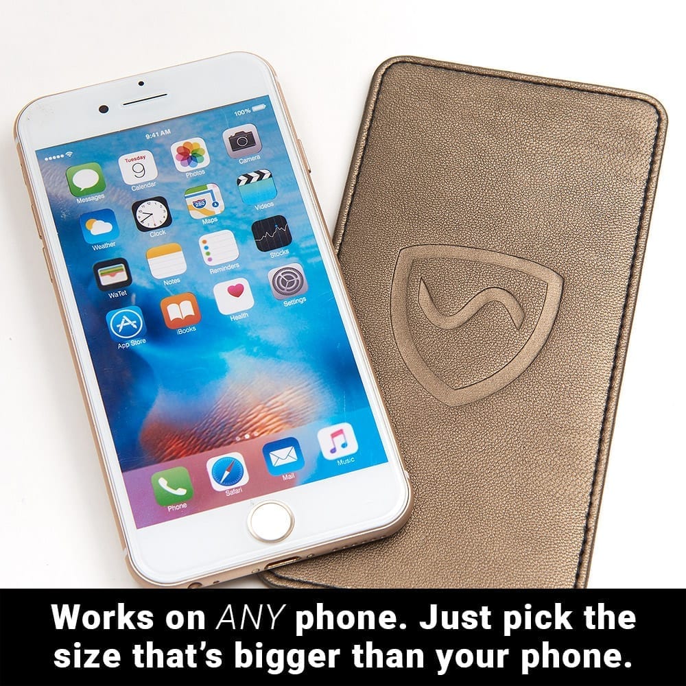 Phone beside a bronze Shield Your Body Phone Shield: works on any phone, pick the size bigger than your phone
