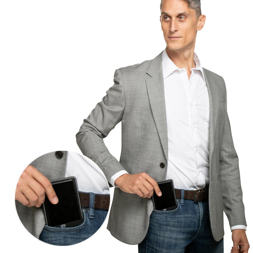 Man in a gray blazer holding a phone and the Shield Your Body Phone Shield, with a close-up of the pocket