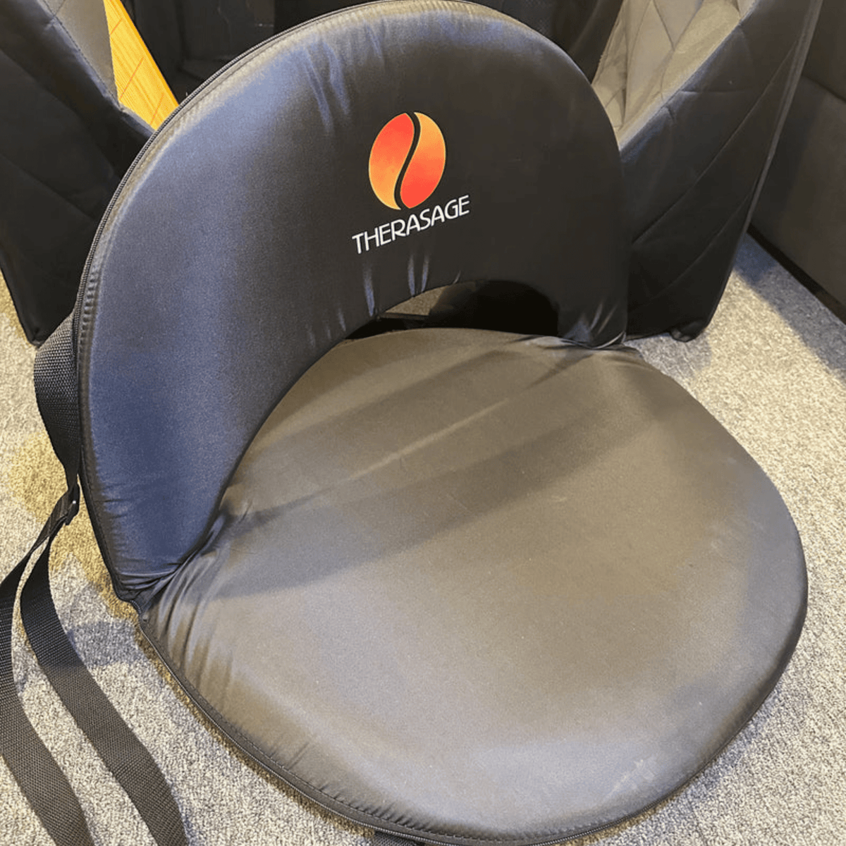 Therasage Thera360 Floor Chair set up on carpet with padded seat and backrest
