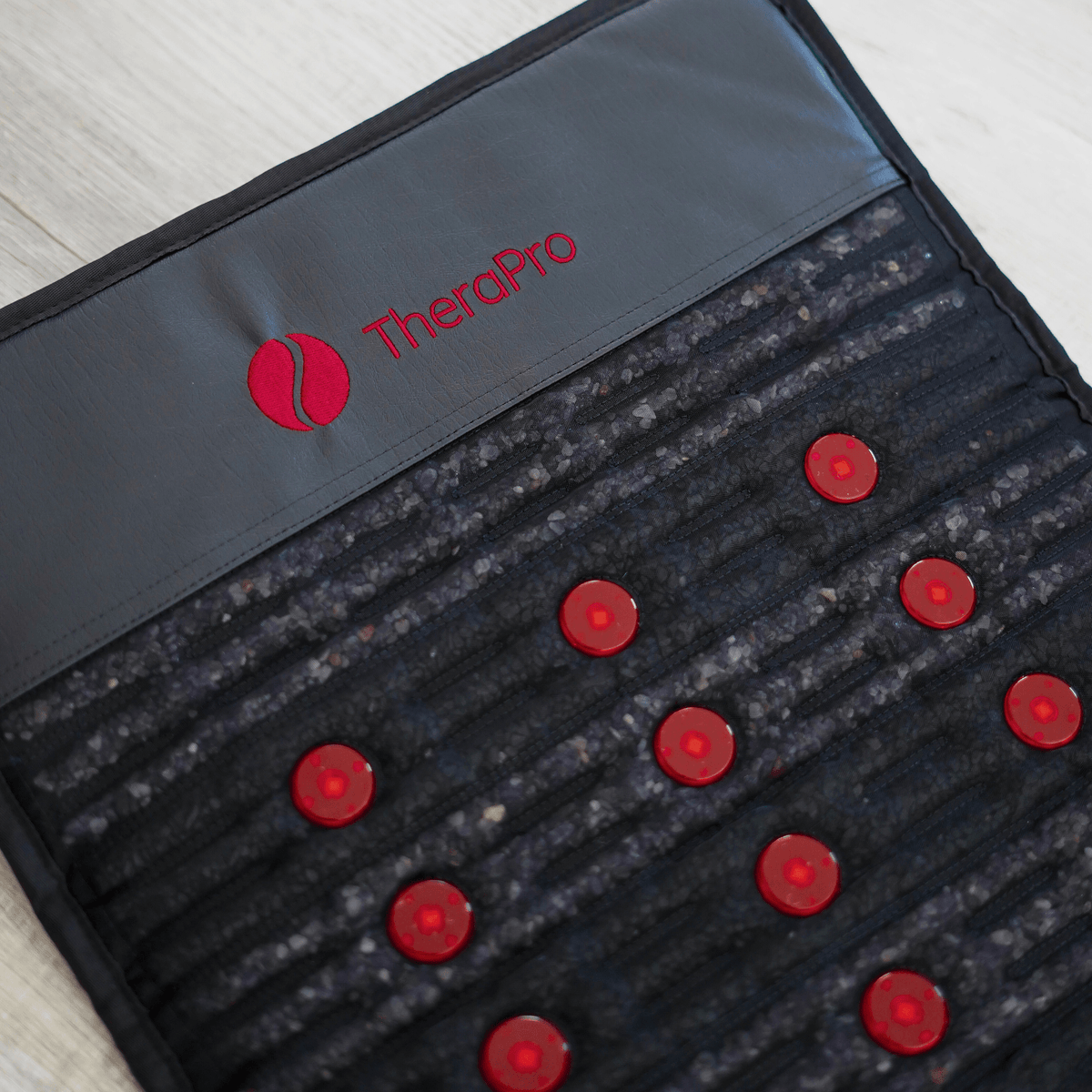Close-up of red light and infrared gemstone surface on the Therasage TheraPro pad