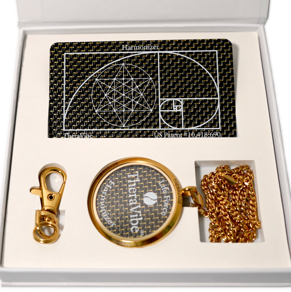 Close-up of the Therasage TheraVibe Quantum Card and gold TheraVibe pendant in the gift box