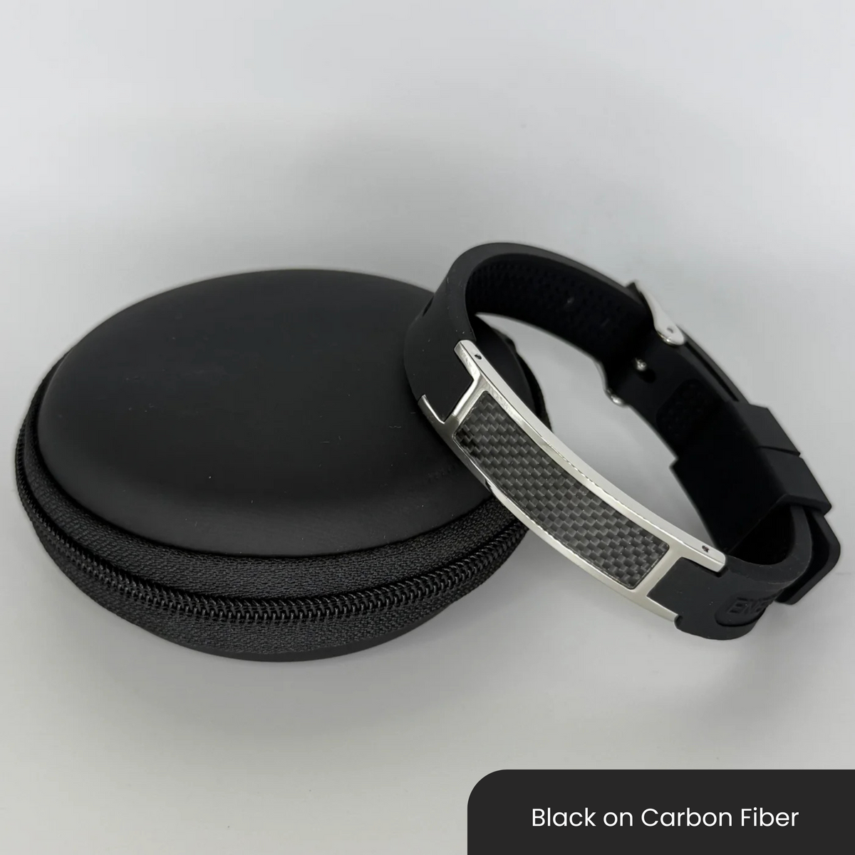 Therasage Bio Band Sport bracelet in Black on Carbon Fiber beside a black zip case