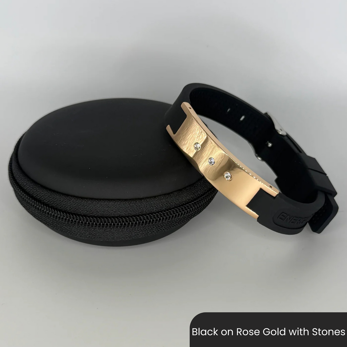 Therasage Bio Band Sport bracelet in Black on Rose Gold with Stones beside a black zip case