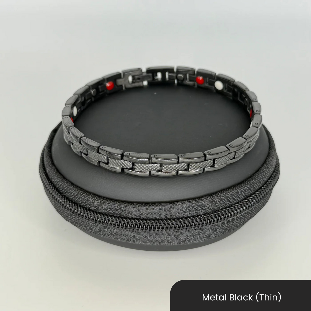 Therasage Bio Band metal bracelet in Metal Black (Thin) on a black zip case