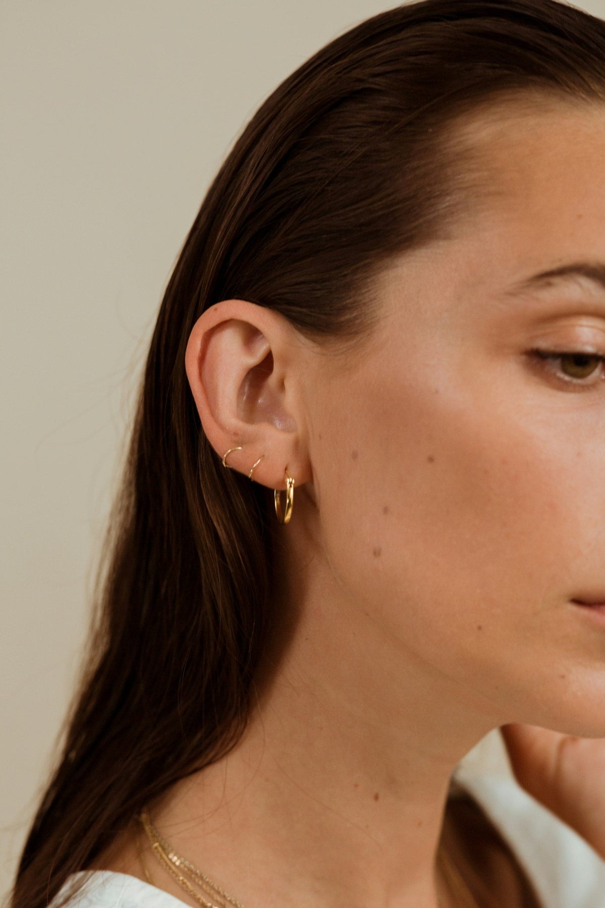Woman in profile with slicked-back hair, styled with Firsthand Supply All-Purpose Pomade