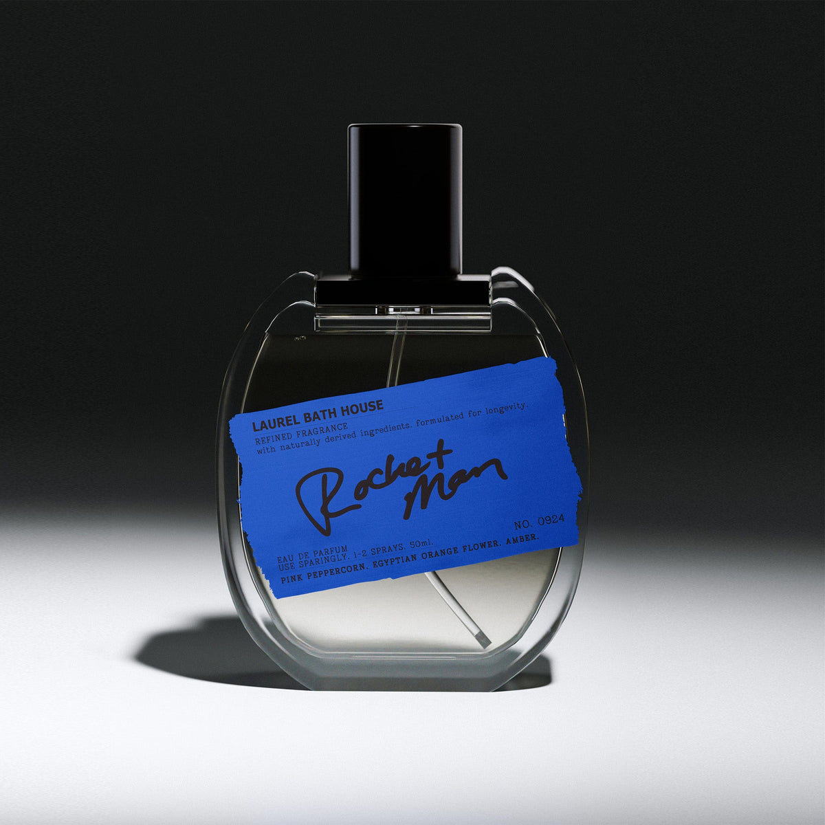 Laurel Bath House Rocket Man Eau de Parfum 50 ml bottle with blue label on a dark spotlit background