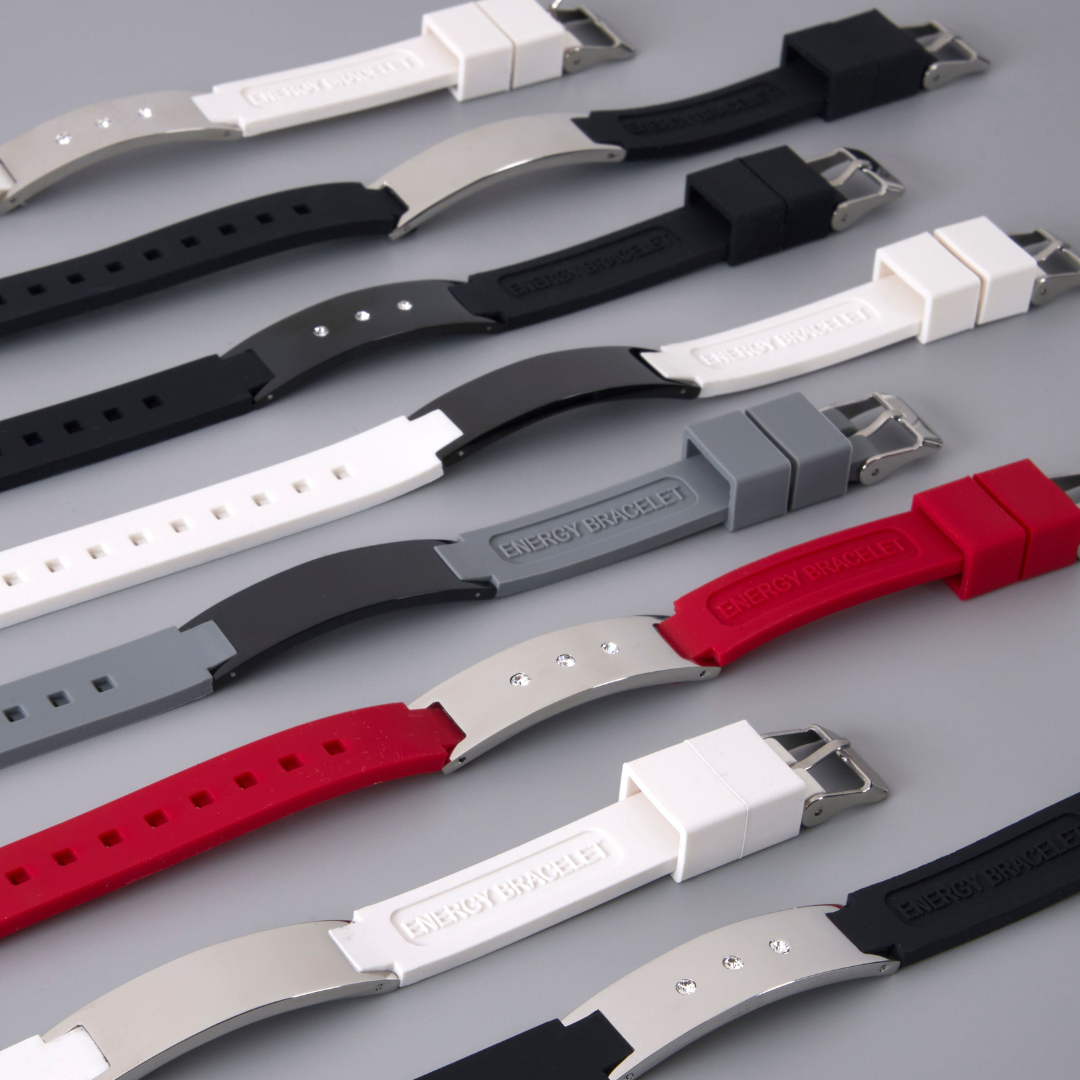 Assortment of Therasage Bio Band Sport silicone bracelets in black, white, gray and red with metal plates