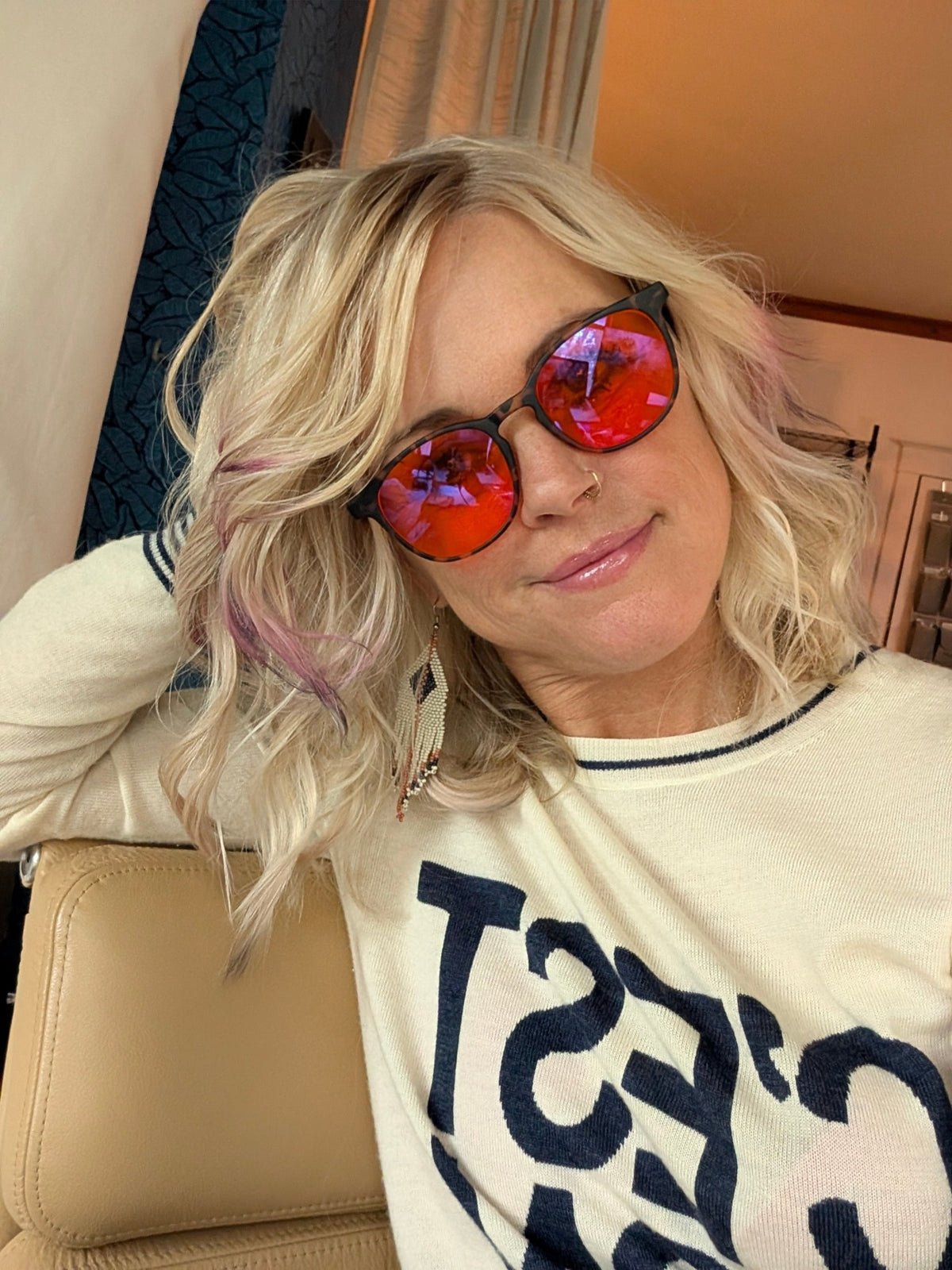 Woman with blonde hair wearing DreamWalkerz Dreamwave Tortoise Shell red-lens sleep glasses