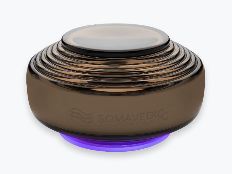 Somavedic Anthracite device in dark bronze glass with a purple base light
