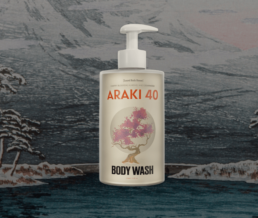 Laurel Bath House Araki 40 body wash bottle in front of a snowy mountain landscape print