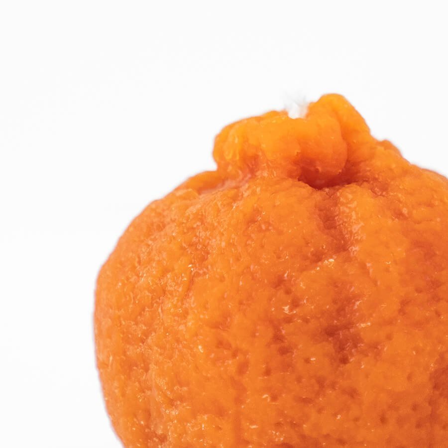Close-up of the textured peel of a Happy Organics Mandarin Orange Beeswax Candle