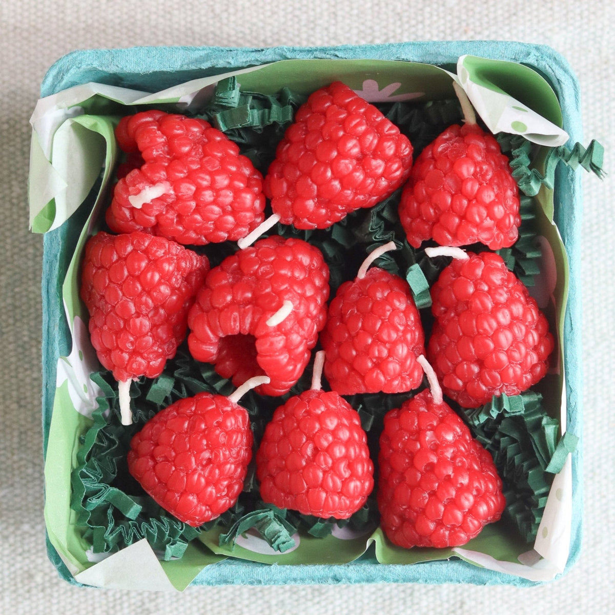 Happy Organics Raspberry Beeswax Birthday Candles in a berry basket