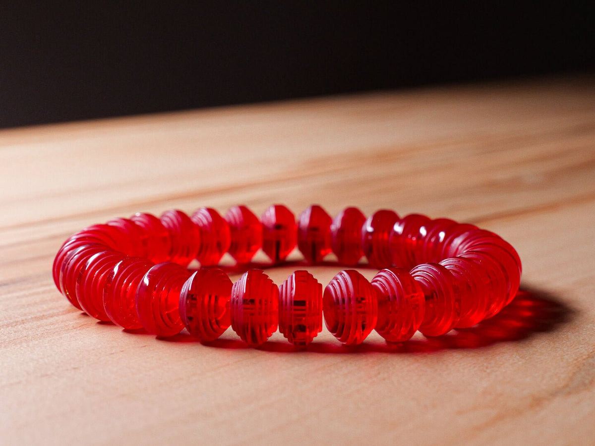 Somavedic red Bracelet on a wooden table
