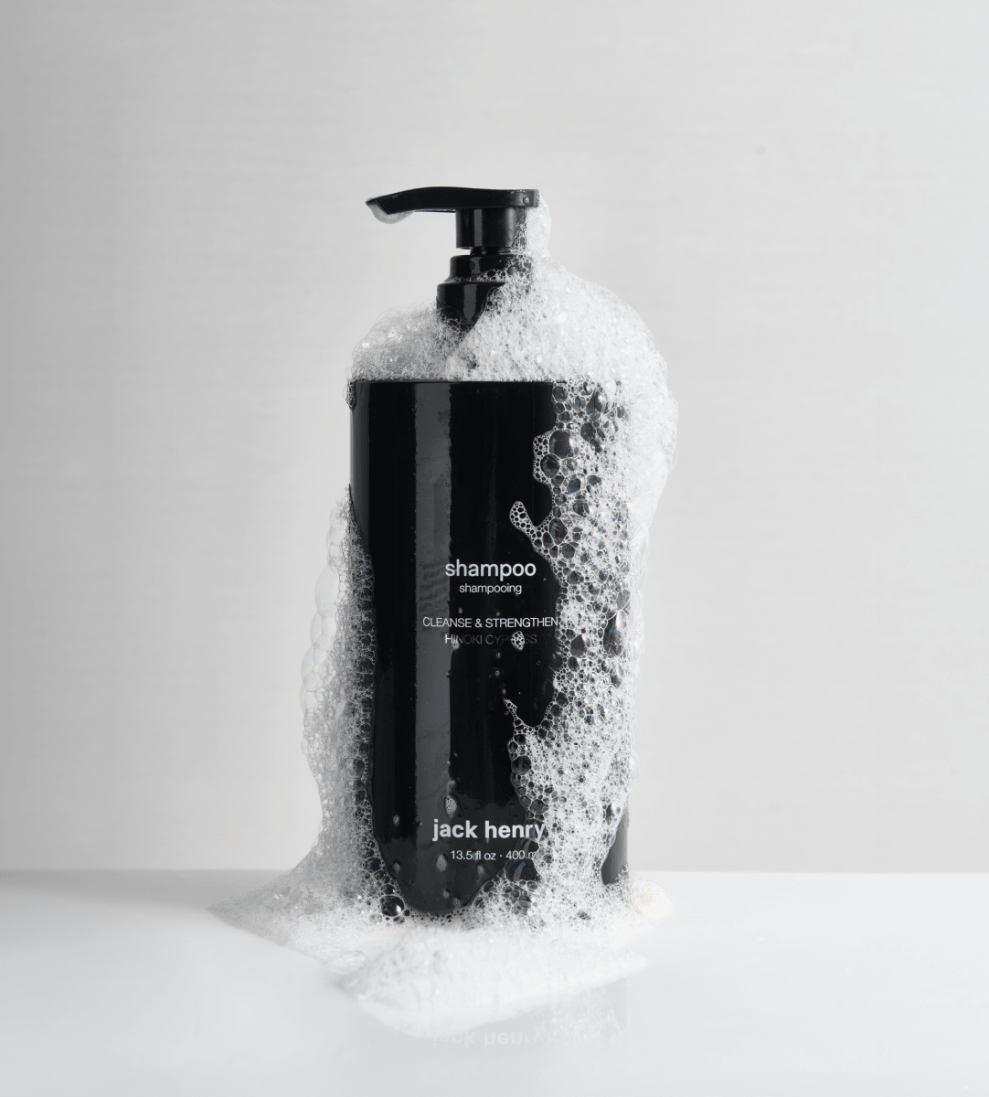 Jack Henry Creamy Shampoo pump bottle covered in foam