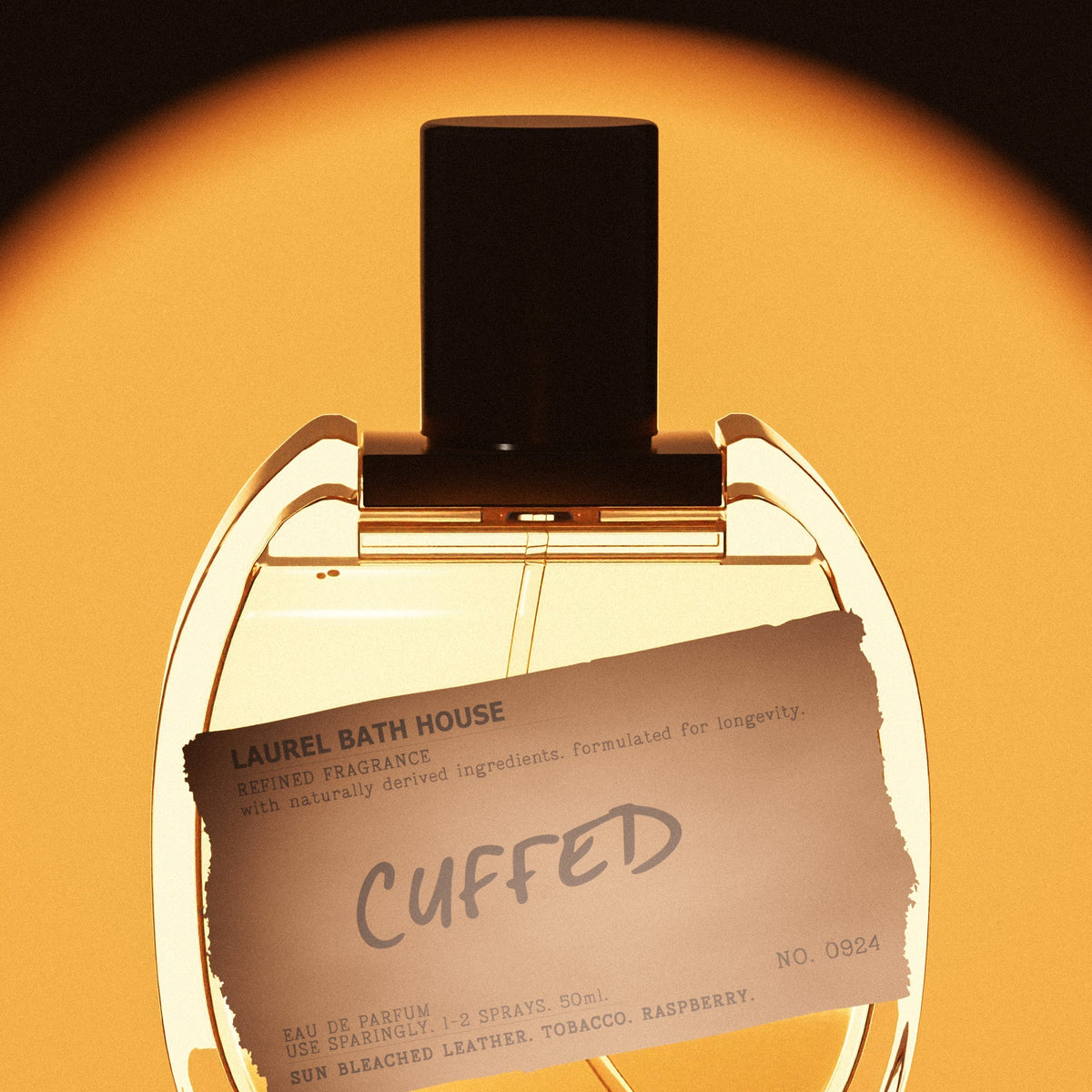 Close-up of the Laurel Bath House Cuffed bottle and its brown torn paper label