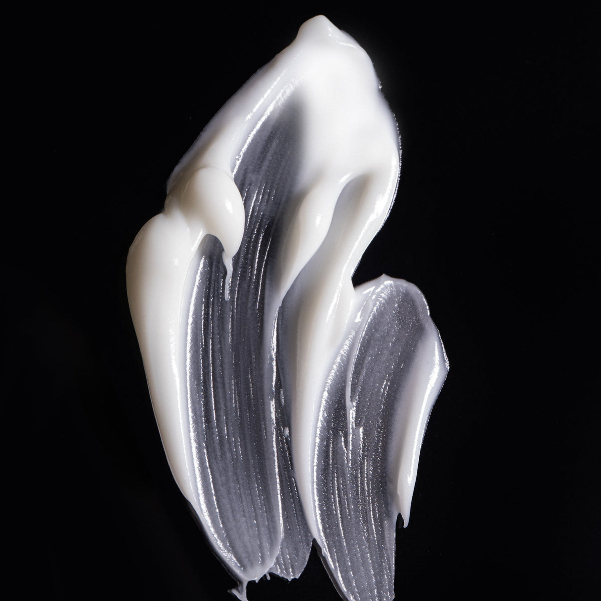 Smear of white Laurel Bath House Daily Drench Body Cream on a black background