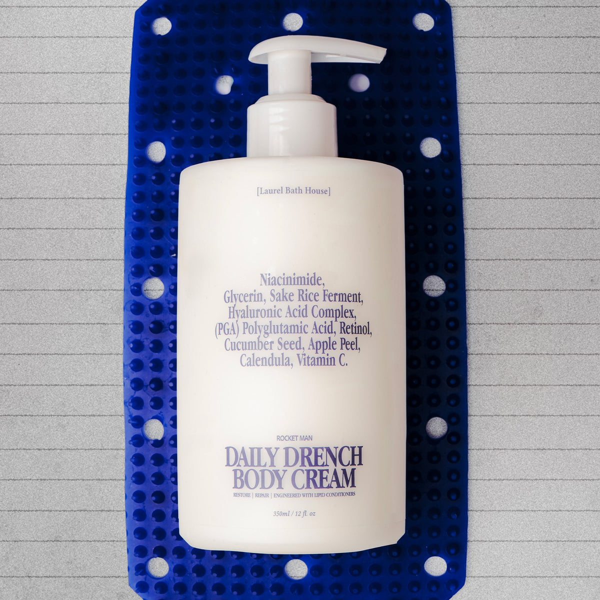 Laurel Bath House Rocket Man Daily Drench Body Cream bottle on a blue silicone mat